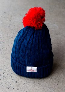 blue little creatures beanie with red pom pom